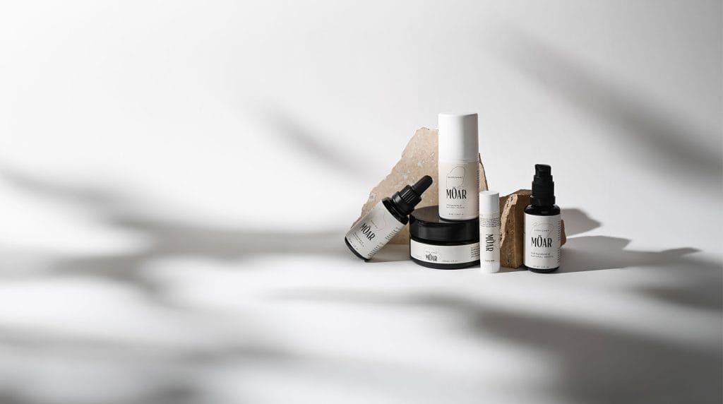 MOAR CBD skincare products arranged in a minimalist lifestyle setting